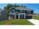 Charming two-story home with a dark blue exterior, brick accents, and a well-manicured lawn at 259 Miramar Dr, York, SC 29745