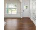 Bright foyer area featuring hardwood floors, white trim, a window, the front door, and french doors at 259 Miramar Dr, York, SC 29745