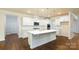 Modern white kitchen featuring stainless steel appliances, large island, and plenty of cabinet space at 259 Miramar Dr, York, SC 29745