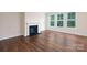 Spacious living room with hardwood floors, fireplace, and large windows offering abundant natural light at 259 Miramar Dr, York, SC 29745