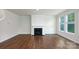 Cozy living room featuring a fireplace, hardwood floors, and bright windows with views of the outdoors at 259 Miramar Dr, York, SC 29745