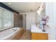 Bright bathroom features a soaking tub, glass-enclosed shower, and a double sink vanity, offering a spa-like experience at 2765 Dogwood Cir, Rock Hill, SC 29732