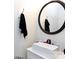 Small bathroom features a single sink vanity with modern fixtures and a sleek, round mirror at 2765 Dogwood Cir, Rock Hill, SC 29732