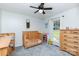 Cozy bedroom with a wooden crib, ceiling fan, large window, and natural light at 2765 Dogwood Cir, Rock Hill, SC 29732