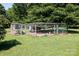 Spacious chicken coop and run with mature trees offer a dedicated space for raising chickens in a backyard setting at 2765 Dogwood Cir, Rock Hill, SC 29732