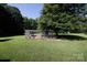 A fenced-in chicken coop sits under the shade of a large tree, offering a safe place for raising poultry at 2765 Dogwood Cir, Rock Hill, SC 29732