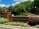 Welcoming community entrance sign with brick pillars, lush greenery, and manicured landscaping at 3036 Luke Crossing Dr, Charlotte, NC 28226