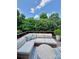 Outdoor deck featuring comfortable seating with stylish pillows and a view of lush trees at 3036 Luke Crossing Dr, Charlotte, NC 28226