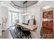 Stylish dining room features a long wooden table, unique lighting, and a cozy atmosphere near a bright window at 3036 Luke Crossing Dr, Charlotte, NC 28226