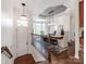 Elegant dining room with tray ceiling, modern lighting, and large windows with sheer curtains at 3036 Luke Crossing Dr, Charlotte, NC 28226