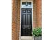 Close-up view of the front door with the house number 3036, framed by brick and greenery at 3036 Luke Crossing Dr, Charlotte, NC 28226