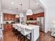 Modern kitchen featuring a marble-topped island, wooden cabinets, and stainless steel appliances at 3036 Luke Crossing Dr, Charlotte, NC 28226