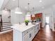 Bright kitchen showcases a large white island with seating, offering an inviting space for cooking and gathering at 3036 Luke Crossing Dr, Charlotte, NC 28226