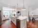 Bright kitchen features a marble island, stainless steel appliances, and pendant lighting at 3036 Luke Crossing Dr, Charlotte, NC 28226