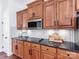 Kitchen featuring wooden cabinets, granite countertops, subway tile backsplash, and modern appliances at 3036 Luke Crossing Dr, Charlotte, NC 28226