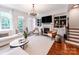 Bright living room featuring a fireplace, built-in shelving, and an elegant chandelier at 3036 Luke Crossing Dr, Charlotte, NC 28226