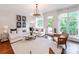 Spacious living room filled with natural light has plush seating, elegant decor, and access to the outdoors at 3036 Luke Crossing Dr, Charlotte, NC 28226