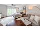 Main bedroom with hardwood floors, large windows, sitting area, and stylish decor at 3036 Luke Crossing Dr, Charlotte, NC 28226