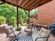 Inviting outdoor patio with comfortable seating, dining area, grill, and a well-maintained brick and wood finish at 3036 Luke Crossing Dr, Charlotte, NC 28226