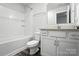 Bright bathroom featuring a vanity with granite countertop and a tiled shower and tub combo at 334 Ladybird Ln, Pineville, NC 28134