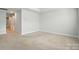 Clean bedroom features neutral carpet and light walls, ready for your personal touch and decor at 334 Ladybird Ln, Pineville, NC 28134