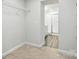 Bedroom leads into bathroom featuring wood floors, a white vanity, and a glass-enclosed shower at 334 Ladybird Ln, Pineville, NC 28134