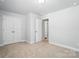 Bedroom with carpet, and white doors and trim, leading to another room at 334 Ladybird Ln, Pineville, NC 28134