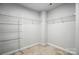 Bright walk-in closet with carpet floors and multiple wire shelves for organized storage at 334 Ladybird Ln, Pineville, NC 28134