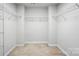 Spacious walk-in closet featuring carpet floors and multiple shelves for optimal storage at 334 Ladybird Ln, Pineville, NC 28134