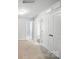 Bright hallway with neutral carpet and white trim showcases access to bedrooms and bathrooms at 334 Ladybird Ln, Pineville, NC 28134