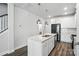 Bright kitchen features stainless steel appliances and an island with a sink and white cabinets at 334 Ladybird Ln, Pineville, NC 28134