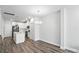 Modern kitchen with white cabinets, stainless steel appliances, an island, and stylish pendant lighting at 334 Ladybird Ln, Pineville, NC 28134