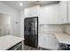 Kitchen with white cabinets, stainless steel appliances, and gray backsplash and countertops at 334 Ladybird Ln, Pineville, NC 28134