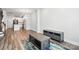 Inviting living room with wood floors, neutral paint, a media center, and a view to the open kitchen concept at 334 Ladybird Ln, Pineville, NC 28134