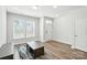 Sun-lit living room with wood-look floors, neutral walls, modern furniture, and ample natural light at 334 Ladybird Ln, Pineville, NC 28134