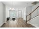 Open living area with wood-look flooring, a staircase, and views into other rooms at 334 Ladybird Ln, Pineville, NC 28134