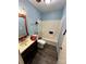 Bathroom with laminate floor, blue walls, toilet, vanity, and shower/tub combo at 3396 Farm Lake Sw Dr, Concord, NC 28027
