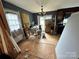 Dining room with a chandelier, white walls and plywood flooring at 3396 Farm Lake Sw Dr, Concord, NC 28027
