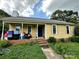 Yellow house with covered porch, storage containers, and a brick foundation at 3396 Farm Lake Sw Dr, Concord, NC 28027