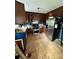 Kitchen with brown cabinets, stainless steel refrigerator and laminate floors at 3396 Farm Lake Sw Dr, Concord, NC 28027