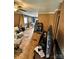 Open living space with plywood flooring, brown walls, and natural light at 3396 Farm Lake Sw Dr, Concord, NC 28027