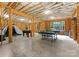 Unfinished basement with open ceiling, exposed framing, games and window views to the yard at 408 Covington Xing, Matthews, NC 28104