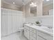 Bright bathroom featuring double sinks and a tiled shower with a shower curtain at 408 Covington Xing, Matthews, NC 28104