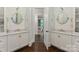 Bathroom with dual vanities, marble countertops, and wood floors providing a balance of style and functionality at 408 Covington Xing, Matthews, NC 28104