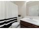 Cozy bathroom with dark vanity, white toilet, and black and white shower curtain at 408 Covington Xing, Matthews, NC 28104