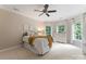 Sunlit bedroom featuring a bed and white dresser under two bright windows at 408 Covington Xing, Matthews, NC 28104