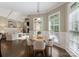 Cozy breakfast nook with large windows, a round table with seating and hardwood floors at 408 Covington Xing, Matthews, NC 28104