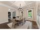 Dining room with coffered ceiling, natural light, and hardwood floors at 408 Covington Xing, Matthews, NC 28104