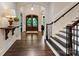 Elegant foyer with hardwood floors, a grand staircase, and a view of the arched front door at 408 Covington Xing, Matthews, NC 28104