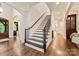Grand foyer with dark hardwood floors and a staircase offering an elegant entrance to the home at 408 Covington Xing, Matthews, NC 28104